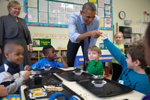 President Barack Obama and a young student touch fingers during at the Community Children's Center, one of the nation's oldest Head Start providers, in Lawrence, Kan., Jan. 22, 2015. (Official White House Photo by Pete Souza)